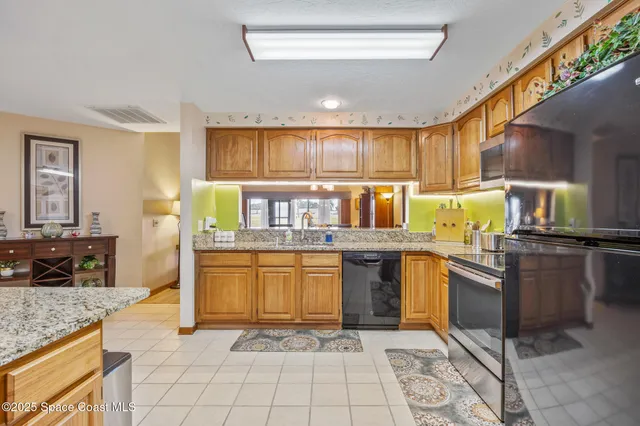 a kitchen with stainless steel appliances granite countertop a sink counter space and cabinets
