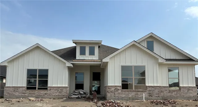 a front view of a house with a yard and porch