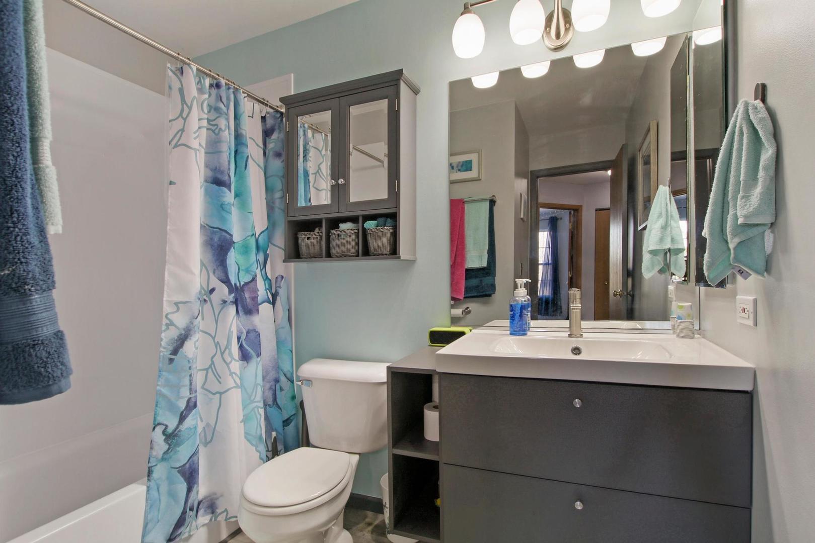 521 Willow Way Lindenhurst, IL 60046 - Photo 16 of 24 a bathroom with a sink vanity mirror and toilet