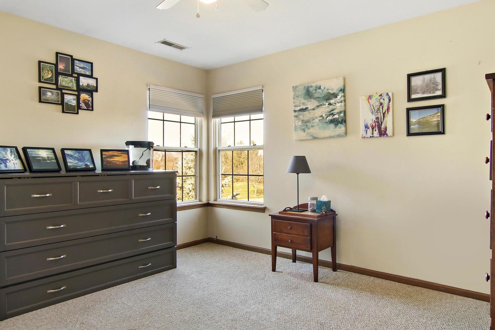 521 Willow Way Lindenhurst, IL 60046 - Photo 17 of 24 a room with a dresser and a window
