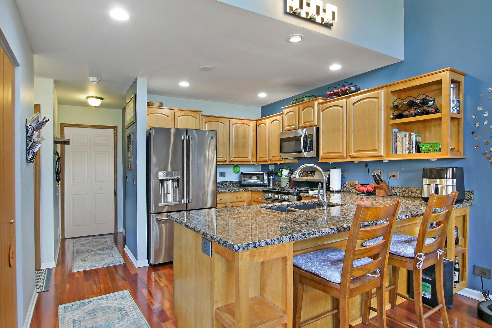 521 Willow Way Lindenhurst, IL 60046 - Photo 2 of 24 a kitchen that has a lot of cabinets and refrigerator in it