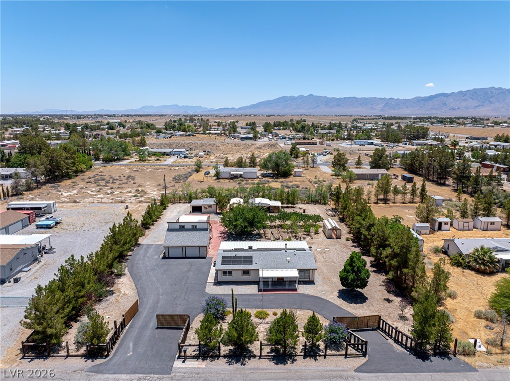 1831 West Horn Road Pahrump, NV 89048 - Photo 2 of 59 Discover a private residence with a paved circular driveway, multiple outbuildings, and mountain vistas.