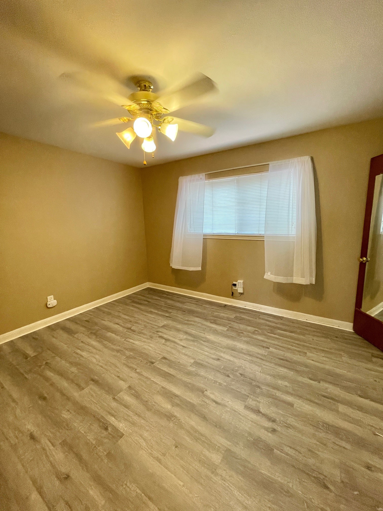 1500 Woodhead Street, Unit 2 Houston, TX 77019 - Photo 20 of 20 a view of an empty room with wooden floor and a window