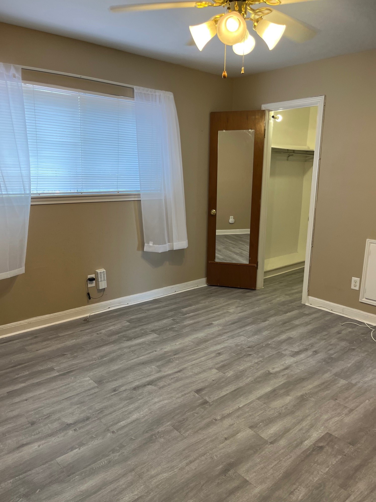 1500 Woodhead Street, Unit 2 Houston, TX 77019 - Photo 4 of 20 a view of an empty room with wooden floor and a window