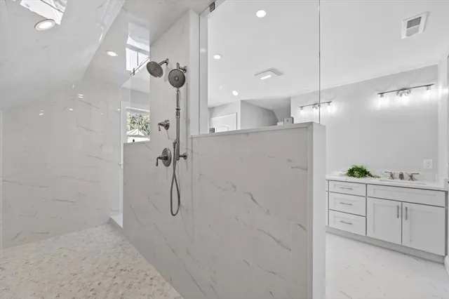 a bathroom with a shower and a sink