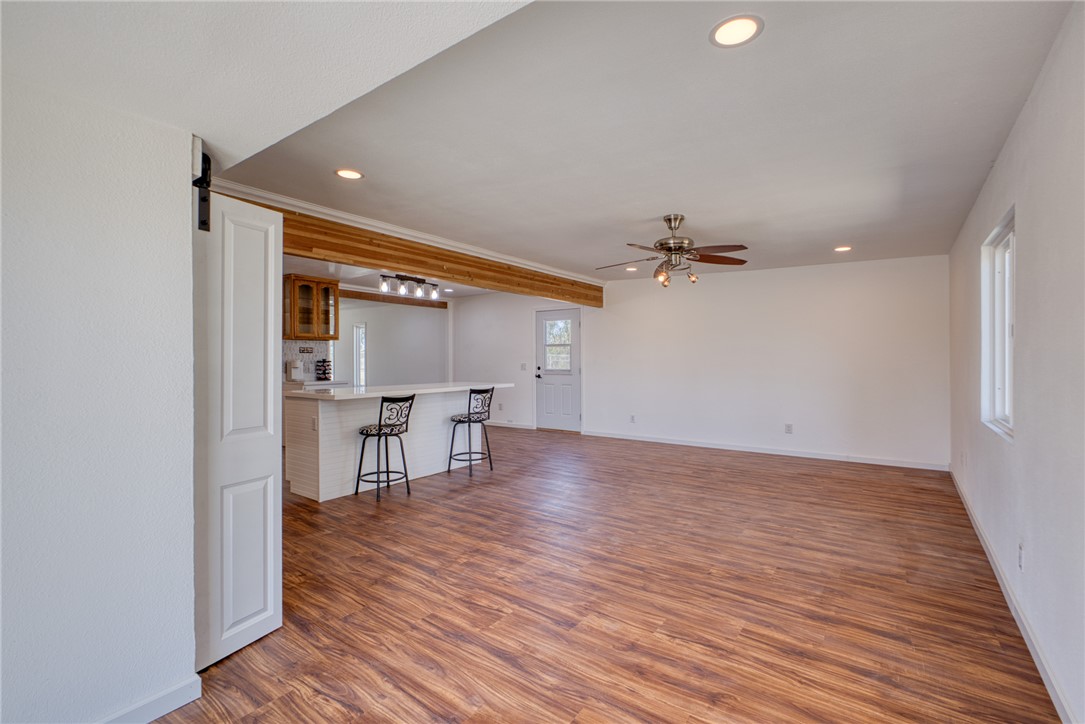 2053 Regents Road Mohave Valley, AZ 86440 - Photo 17 of 65 Open concept living area featuring wood-look flooring, a ceiling fan with light fixture, and recessed lighting