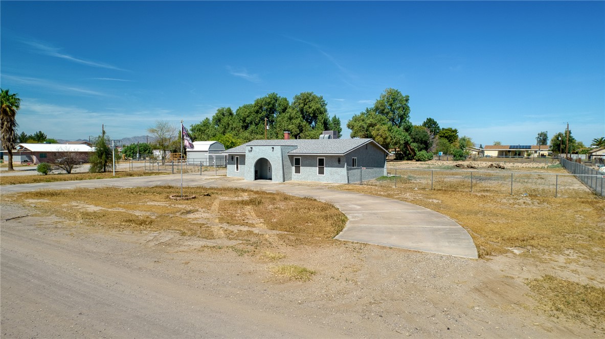 2053 Regents Road Mohave Valley, AZ 86440 - Photo 2 of 65 The property features a single-story residence with an arched entrance and a circular driveway
