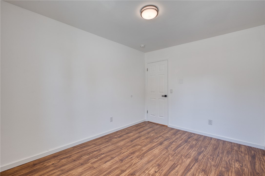 2053 Regents Road Mohave Valley, AZ 86440 - Photo 20 of 65 This room features wood-look flooring, white walls, and a white interior door