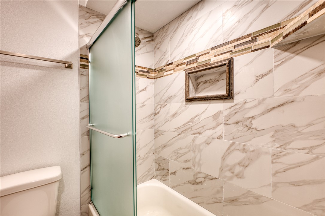 2053 Regents Road Mohave Valley, AZ 86440 - Photo 24 of 65 The bathroom features a shower and bathtub combination with a glass shower door