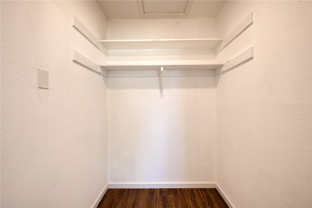 2053 Regents Road Mohave Valley, AZ 86440 - Photo 28 of 65 This space features white walls, dark wood flooring, and built-in shelving