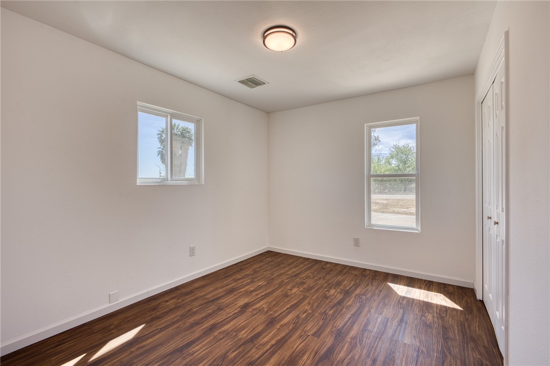 2053 Regents Road Mohave Valley, AZ 86440 - Photo 33 of 65 This room features attractive wood-style flooring, white walls, and a ceiling-mounted light fixture