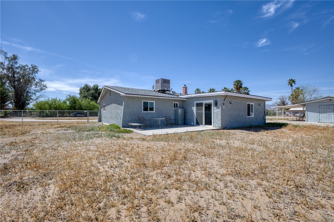 2053 Regents Road Mohave Valley, AZ 86440 - Photo 44 of 65 The property features a gray stucco exterior with a gray shingle roof and white-framed windows