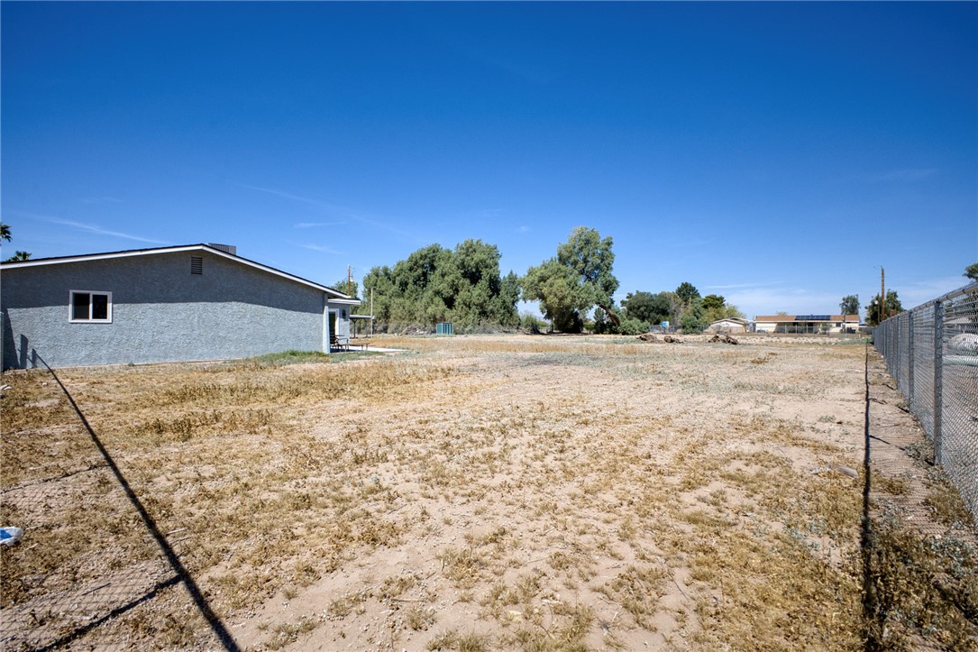 2053 Regents Road Mohave Valley, AZ 86440 - Photo 45 of 65 The property features an expansive lot with a chain-link fence defining one boundary