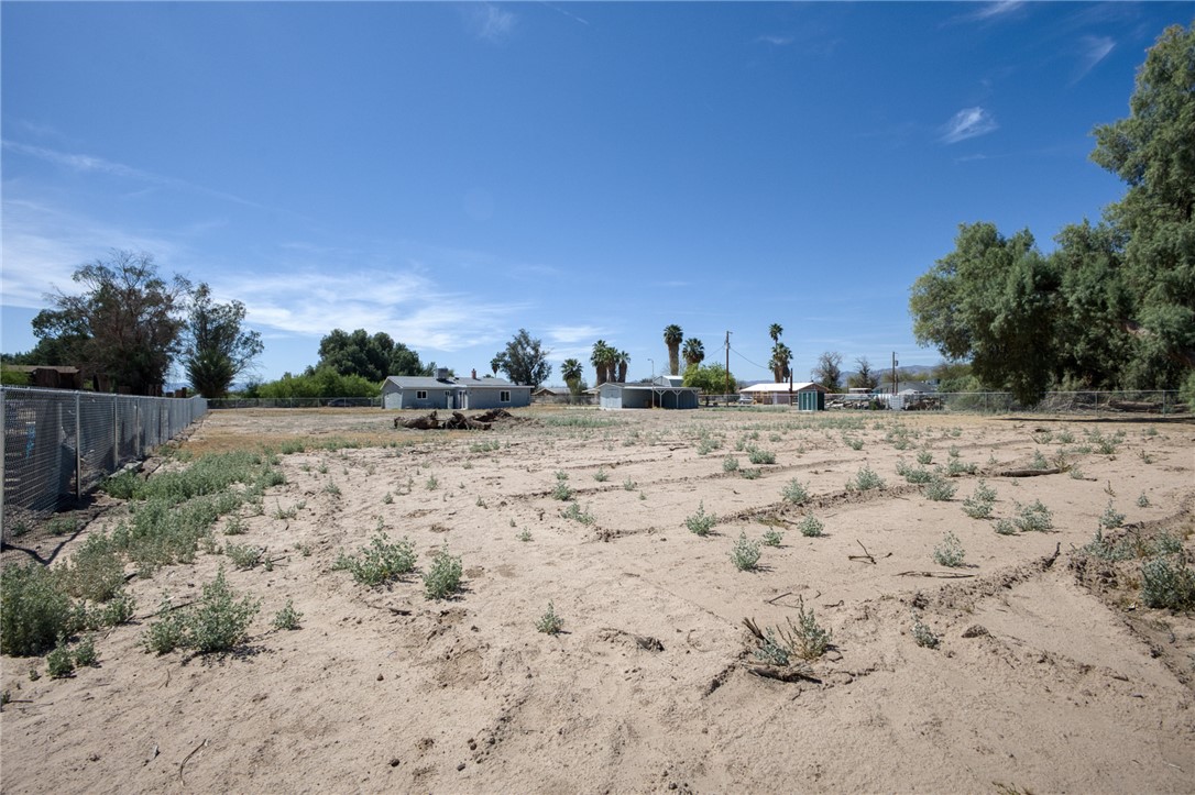 2053 Regents Road Mohave Valley, AZ 86440 - Photo 46 of 65 This property features a large open expanse of land, partially fenced with a chain-link fence