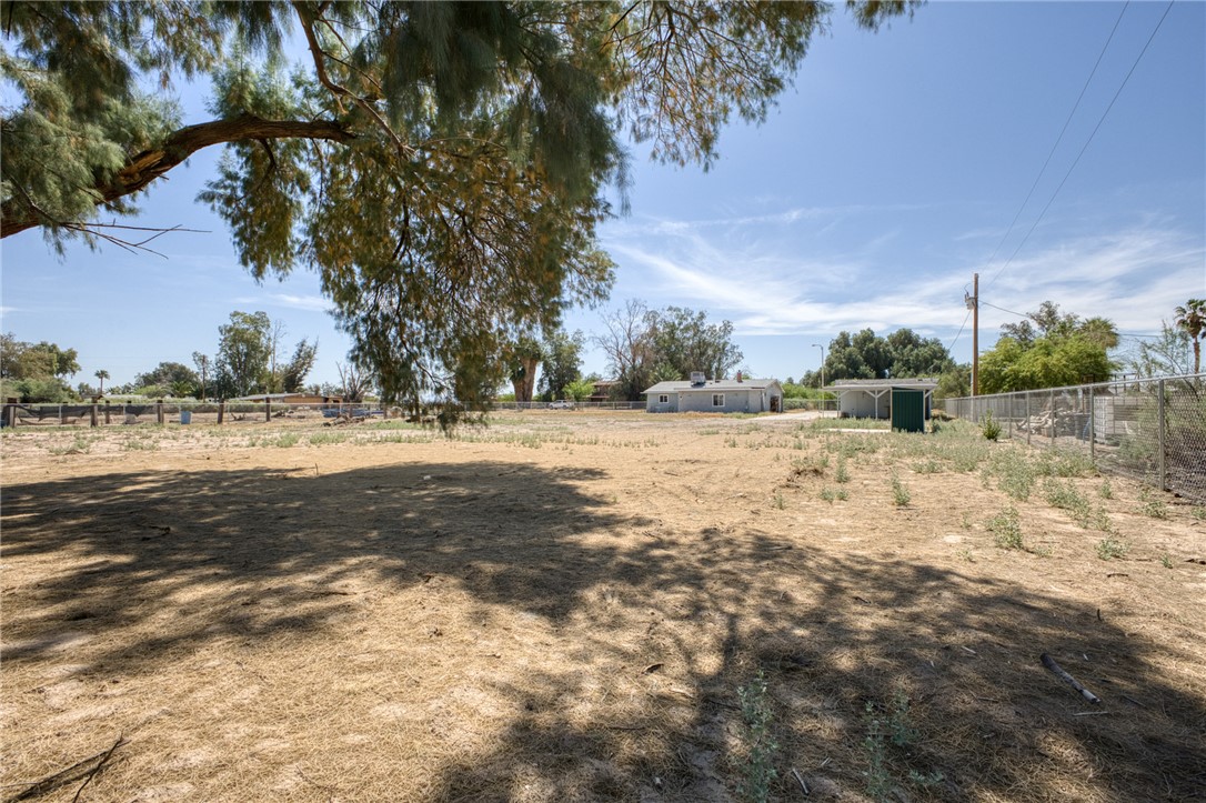 2053 Regents Road Mohave Valley, AZ 86440 - Photo 47 of 65 The property features a spacious land parcel with mature trees providing shade, and a chain link fence