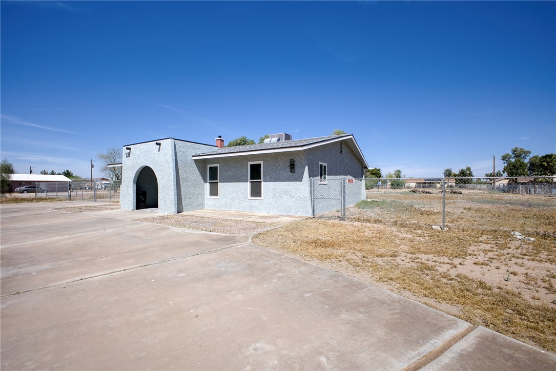 2053 Regents Road Mohave Valley, AZ 86440 - Photo 52 of 65 This property features a stucco exterior with an arched entryway and several windows