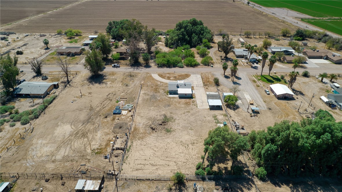 2053 Regents Road Mohave Valley, AZ 86440 - Photo 61 of 65 This property features a single-story residence with a light-colored roof and an attached carport, set on a large lot with a circular driveway