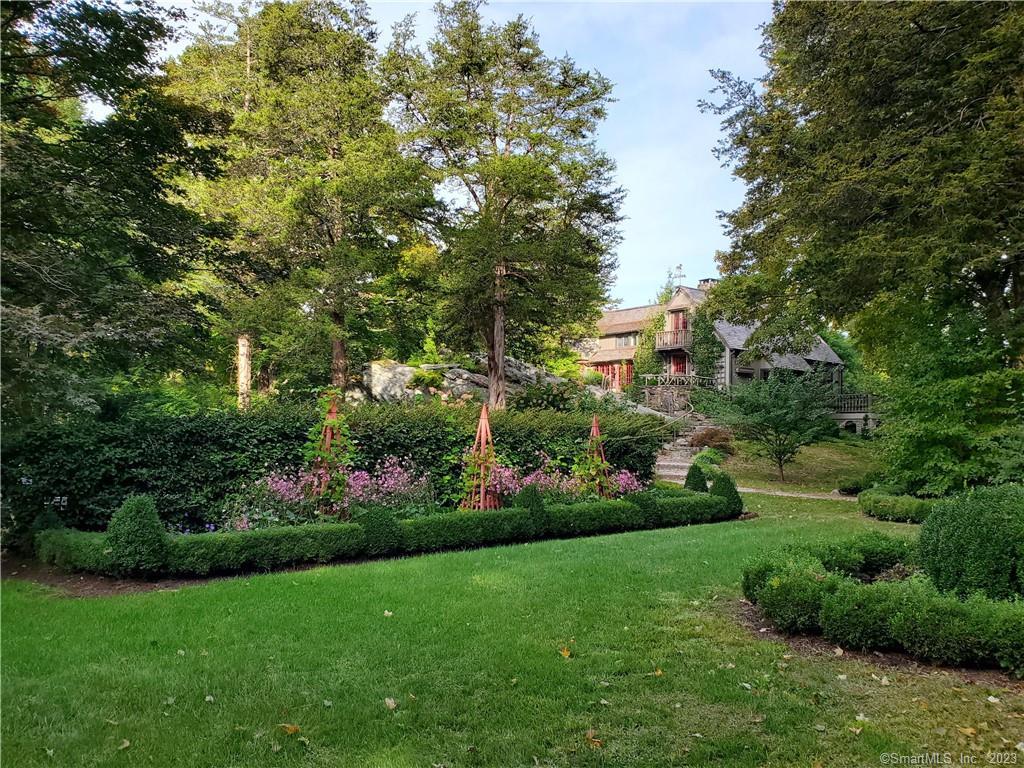 258 Poverty Hollow Road Redding, CT 06896 - Photo 1 of 1 a view of a garden with a fountain