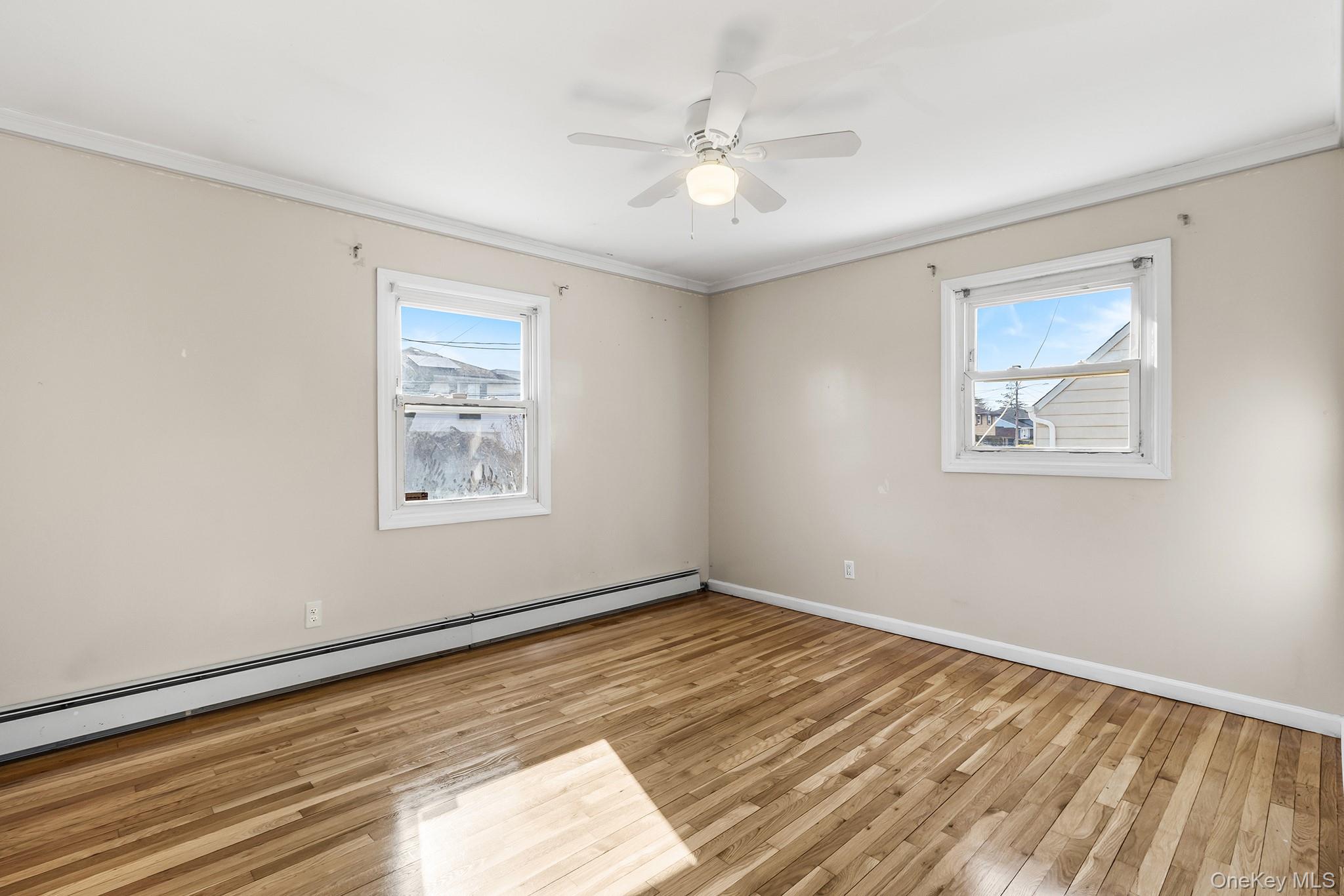 119 Osborne Road West Hempstead, NY 11552 - Photo 15 of 34 a view of an empty room with wooden floor and a window