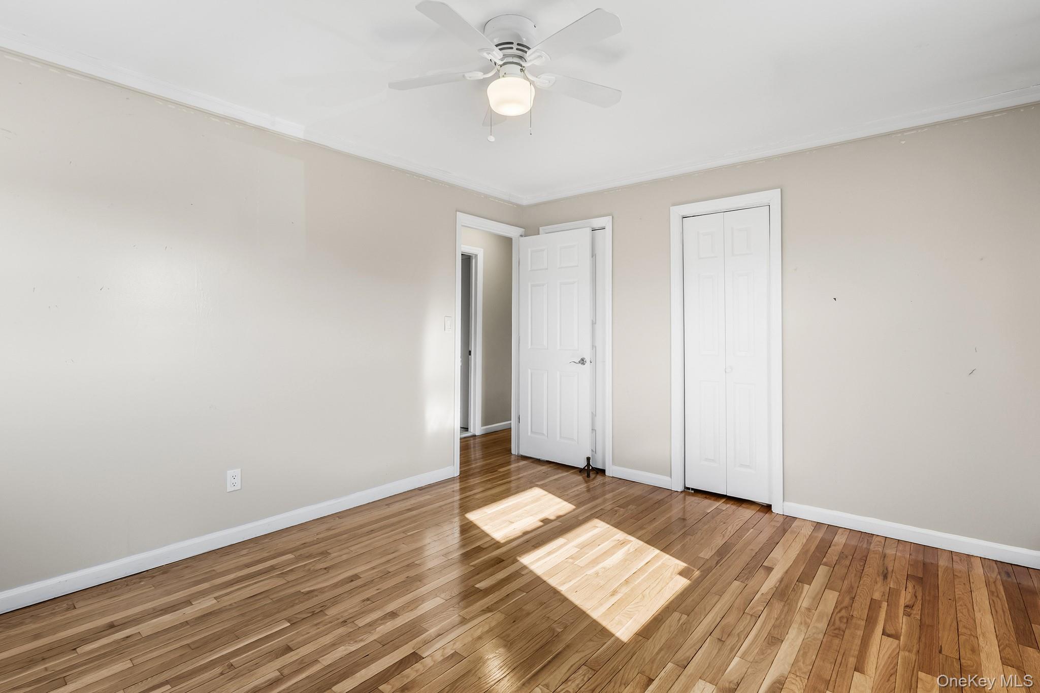 119 Osborne Road West Hempstead, NY 11552 - Photo 16 of 34 a view of empty room with wooden floor and fan