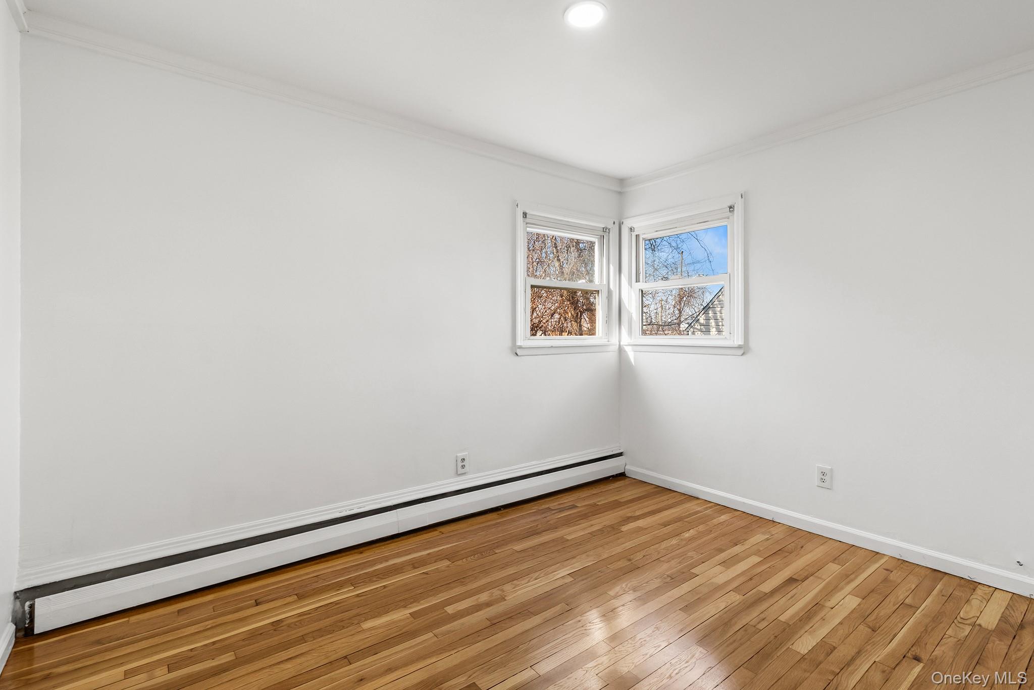 119 Osborne Road West Hempstead, NY 11552 - Photo 17 of 34 a view of a room with wooden floor and window