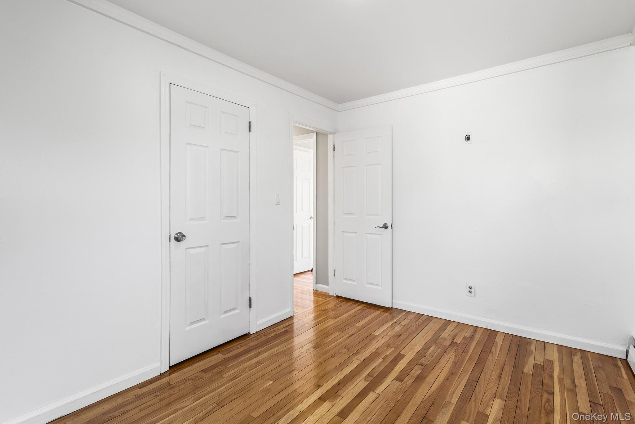 119 Osborne Road West Hempstead, NY 11552 - Photo 18 of 34 a view of an empty room with wooden floor