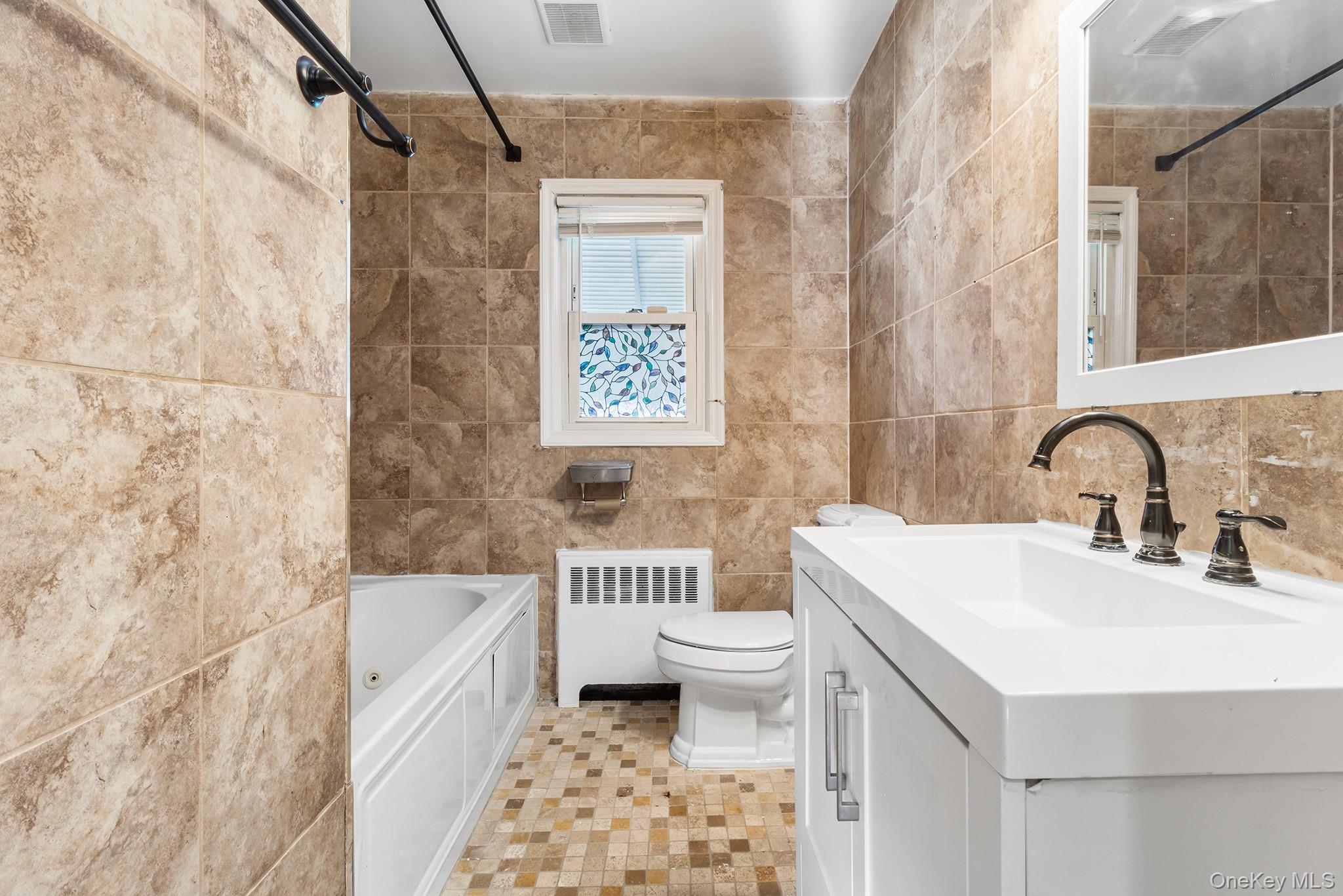 119 Osborne Road West Hempstead, NY 11552 - Photo 19 of 34 a bathroom with a sink toilet and shower