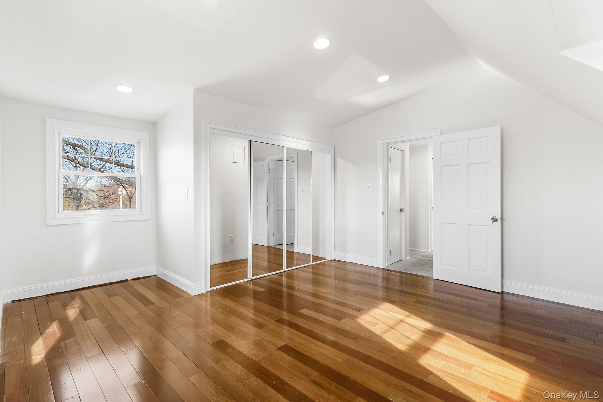 119 Osborne Road West Hempstead, NY 11552 - Photo 22 of 34 a view of an empty room with wooden floor