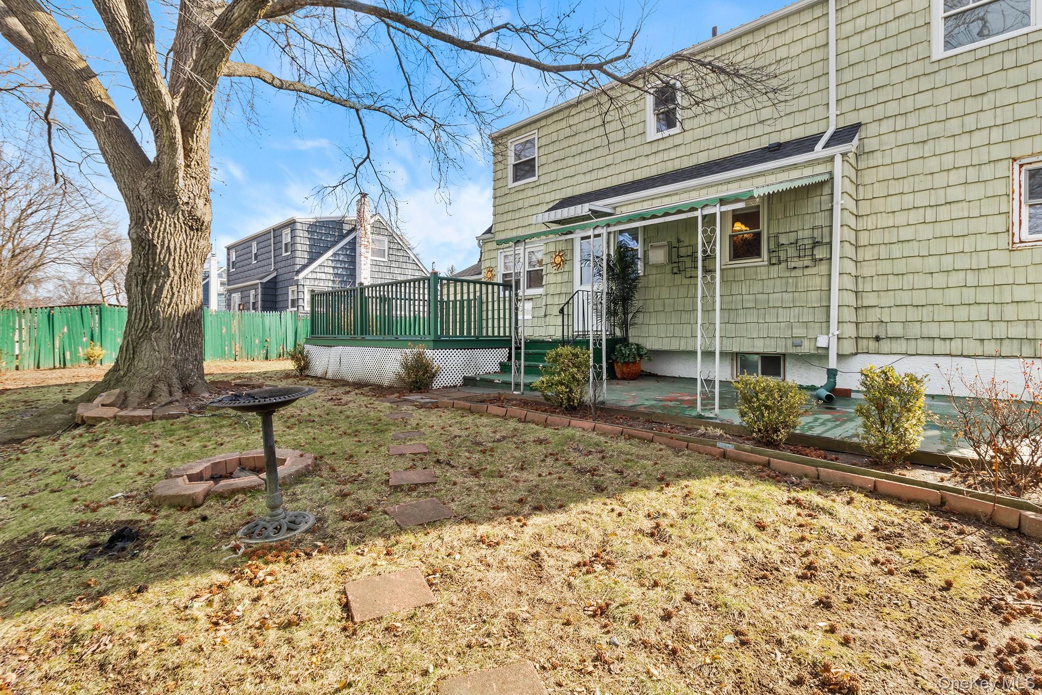119 Osborne Road West Hempstead, NY 11552 - Photo 32 of 34 a view of a house with a backyard and a tree