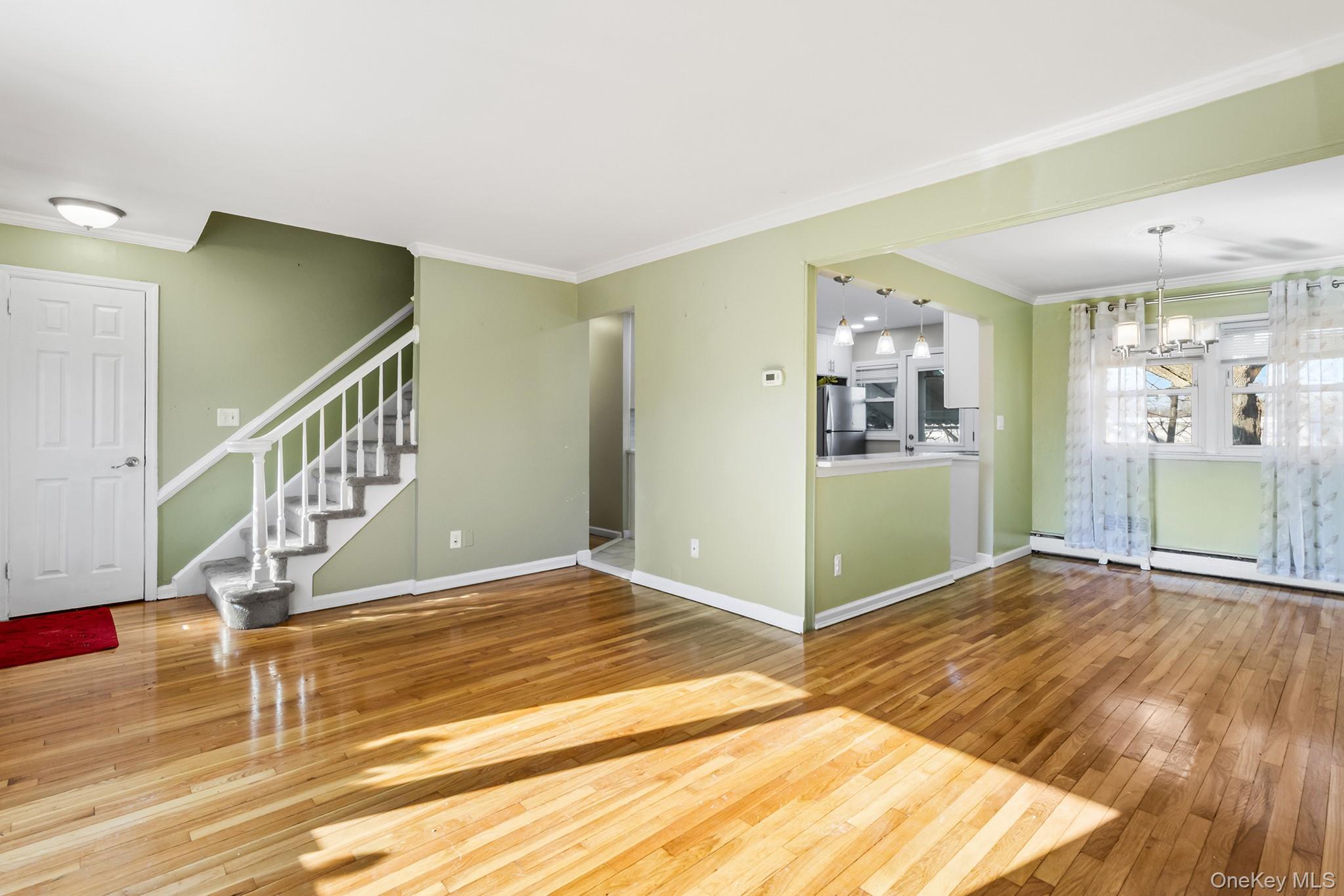 119 Osborne Road West Hempstead, NY 11552 - Photo 4 of 34 a view of a hallway view with wooden floor and staircase
