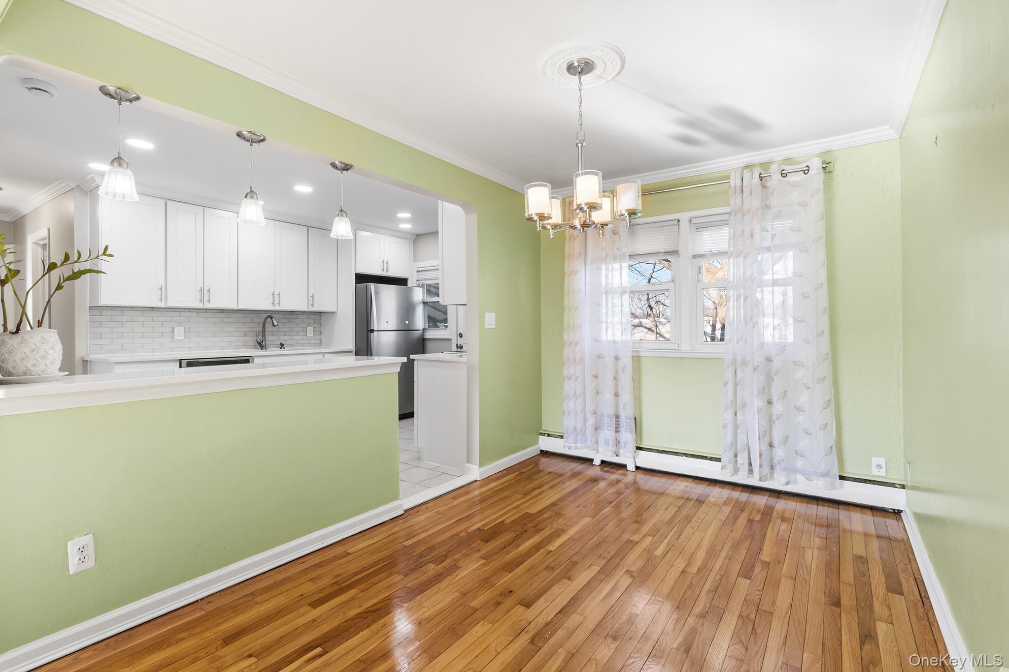 119 Osborne Road West Hempstead, NY 11552 - Photo 9 of 34 a view of a kitchen with wooden floor and a window