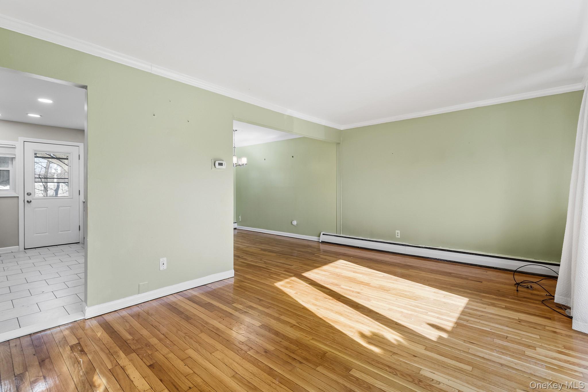 119 Osborne Road West Hempstead, NY 11552 - Photo 10 of 34 a view of a room with wooden floor