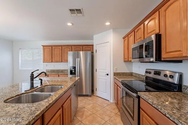 a kitchen that has a sink and a stove