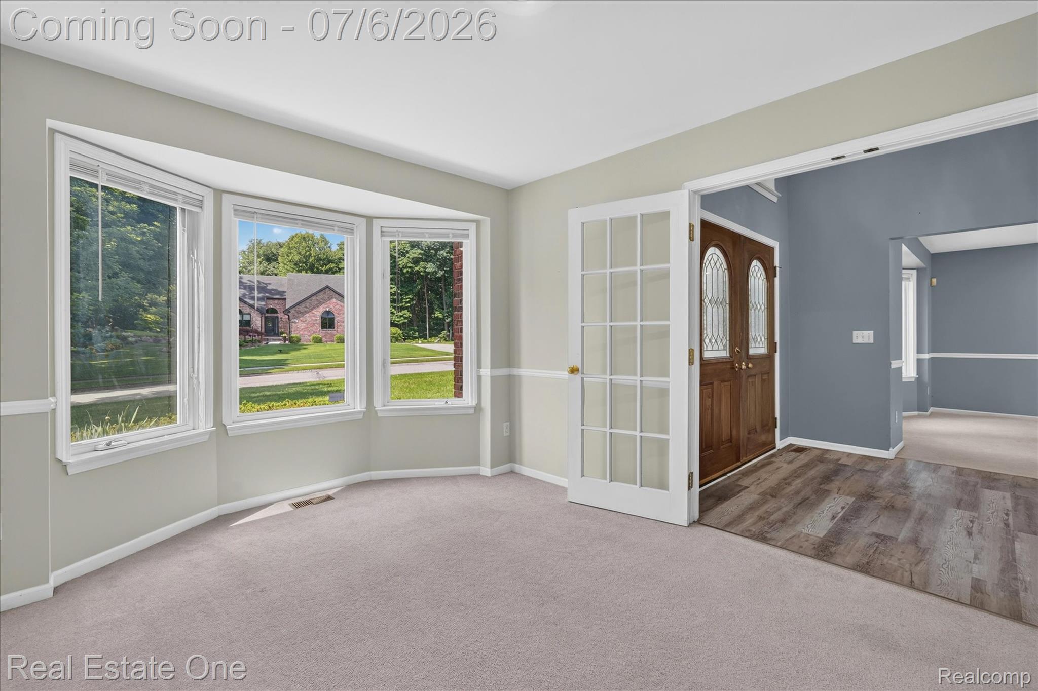 9610 Forest Ridge Drive Clarkston, MI 48348 - Photo 6 of 77 Just off the entry, a private office is thoughtfully positioned to the right, featuring a larger, dramatic bay window that fills the space with natural light. The glass in the French doors provides separation while maintaining a connected, open feel, blending privacy with the home’s overall flow.