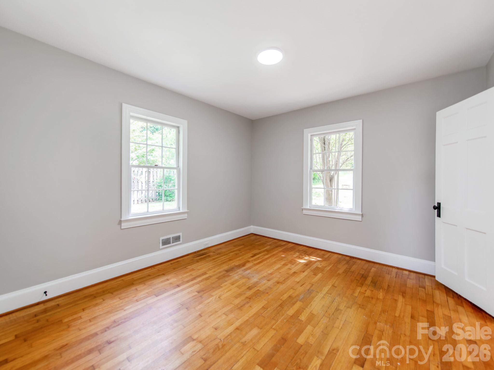 113 Falls Street Morganton, NC 28655 - Photo 11 of 33 wooden floor in an empty room with a window