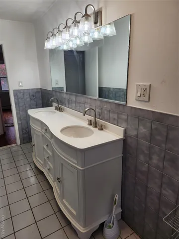 a spacious bathroom with a double vanity sink and a mirror