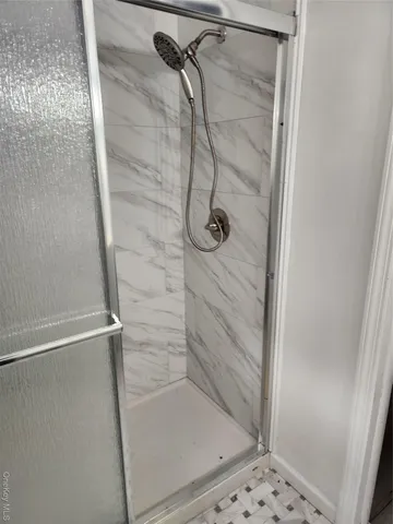 a bathroom with a glass shower door