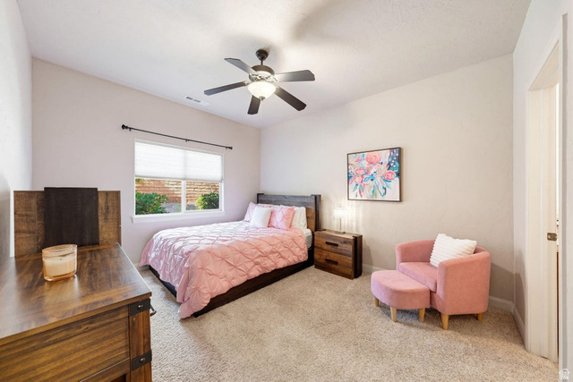 1609 East 10 S Street St. George, UT 84790 - Photo 42 of 68 Neutral toned bedroom with soft carpeting, featuring a window with blinds, a ceiling fan with integrated lighting, and a wood-finish headboard