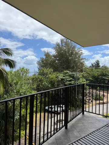 a view of balcony with wooden floor