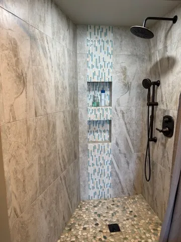 a bathroom with a glass shower door