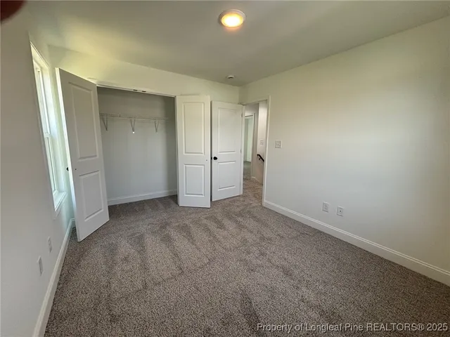 a view of room with a ceiling fan