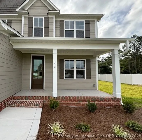 a view of house with outdoor space and porch