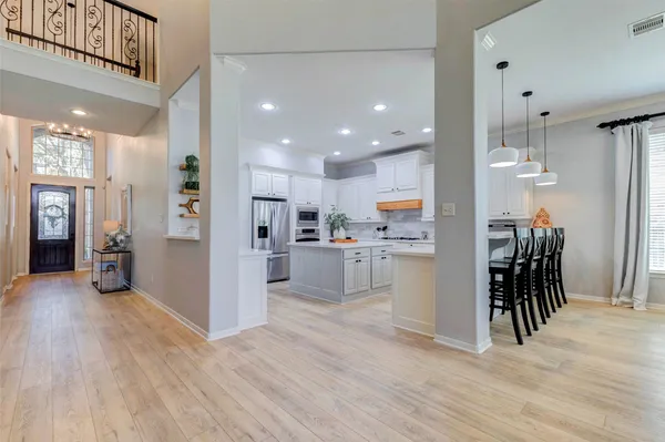 a view of a dining room with furniture and a flat screen tv