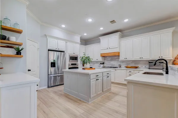 a living room with furniture flat screen tv and a large window