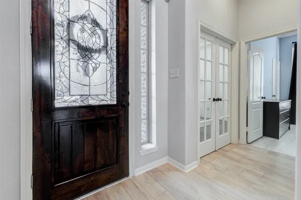 a view of a entrance door with wooden floor