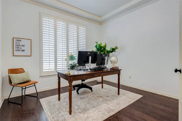a view of a workspace with furniture and a window