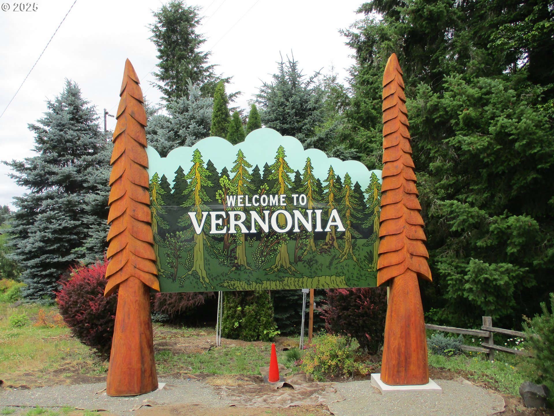 1153 2nd Avenue Vernonia, OR 97064 - Photo 24 of 27 a sign board with flower plants and wooden fence