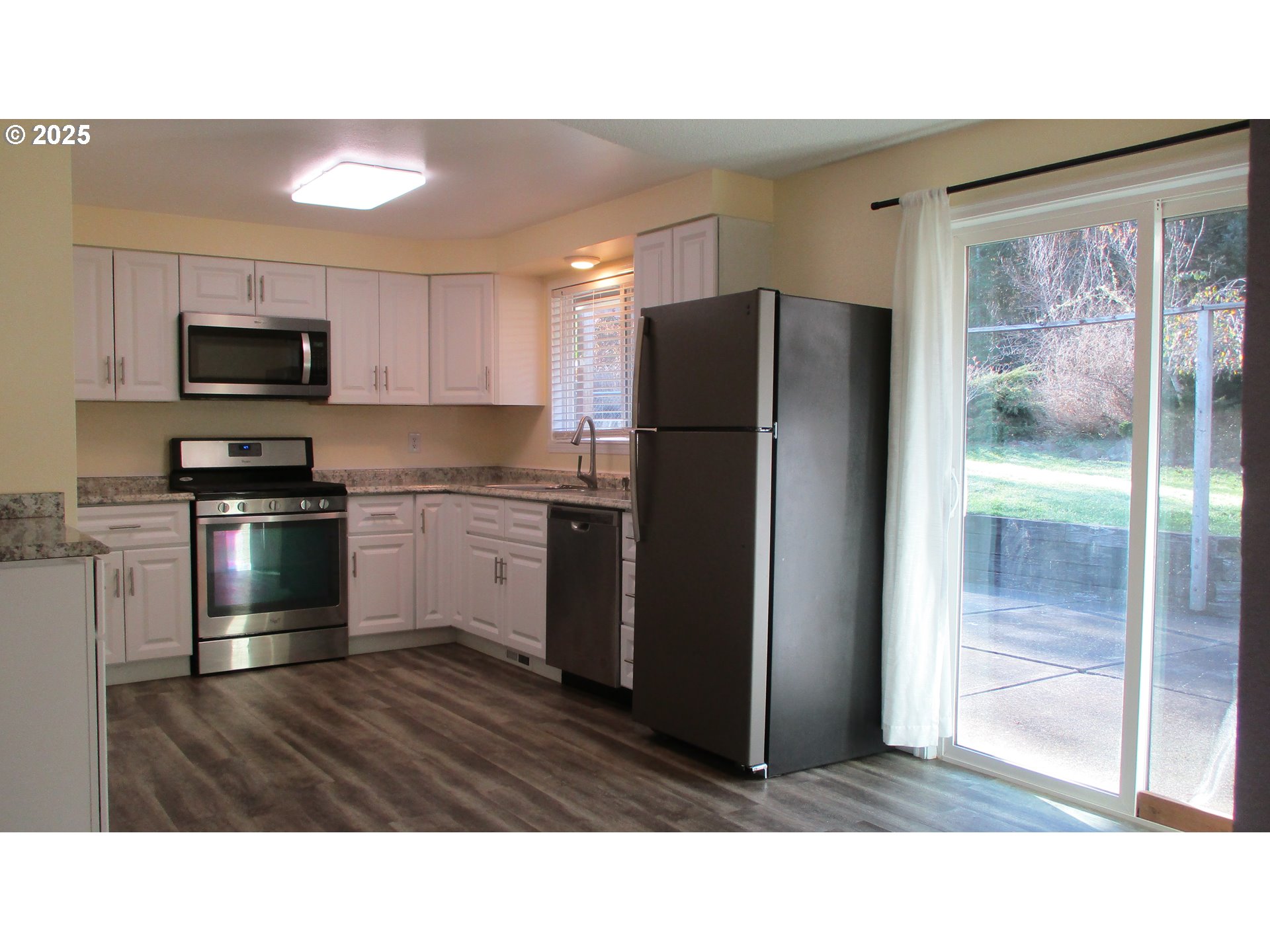 1153 2nd Avenue Vernonia, OR 97064 - Photo 7 of 27 a kitchen with a refrigerator and a sink
