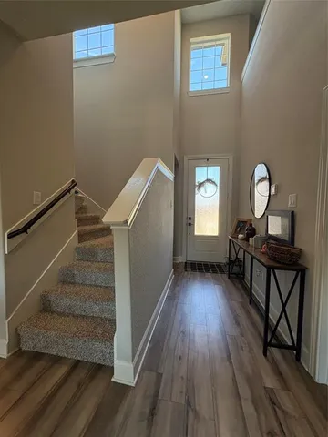 a view of entryway and hall with wooden floor