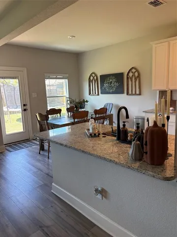 a kitchen with sink a table and chairs